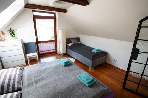a bedroom with two beds and a window at Vinařství Pod hradem in Klentnice