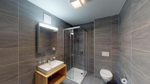 a bathroom with a sink and a shower and a toilet at Les Mayens MB 010 - LUXURY apartment 8 pers in Veysonnaz