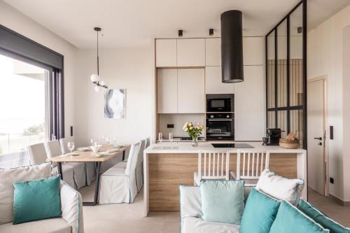 a kitchen and dining room with a table and chairs at Villa Gaya in Polykhrono