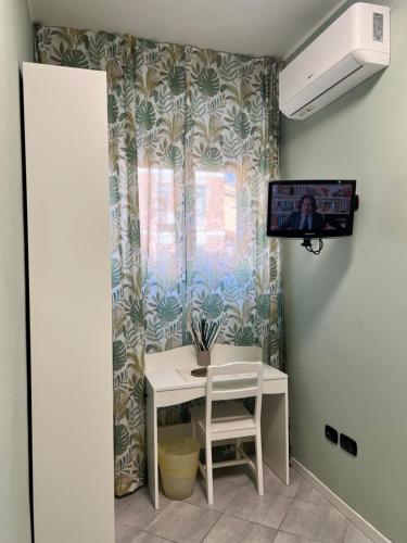a room with a table and a tv and a window at Guest House Esty in Rome