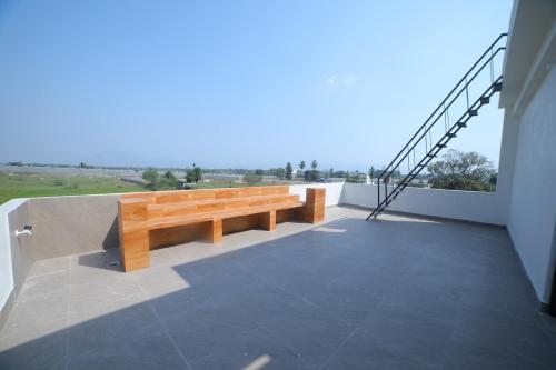 a wooden bench sitting on top of a balcony at Suhana Aangan Homestay in Tirupati