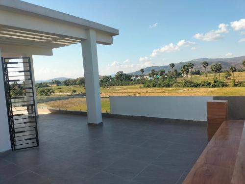 a porch with a view of a field at Suhana Aangan Homestay in Tirupati