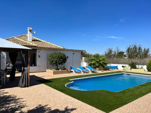 a villa with a swimming pool in a yard at La Casa Arboleas in Arboleas