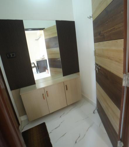 a bathroom with a vanity with a mirror and a sink at Suhana Aangan Homestay in Tirupati