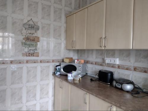 a kitchen with white cabinets and a counter top at La Casa Arboleas in Arboleas
