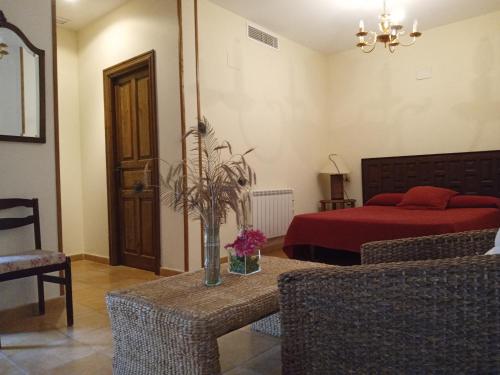 a bedroom with a bed and a table and chairs at Jayca in Trujillo
