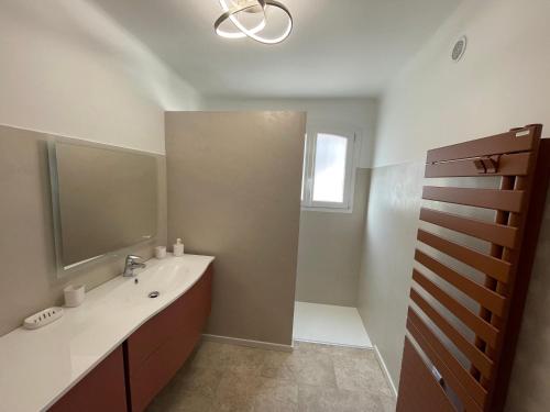 une salle de bain avec un lavabo et un miroir dans l'établissement L'Abri Côtier, à La Ciotat