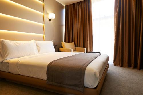 Ένα ή περισσότερα κρεβάτια σε δωμάτιο στο City Stay Bishkek
