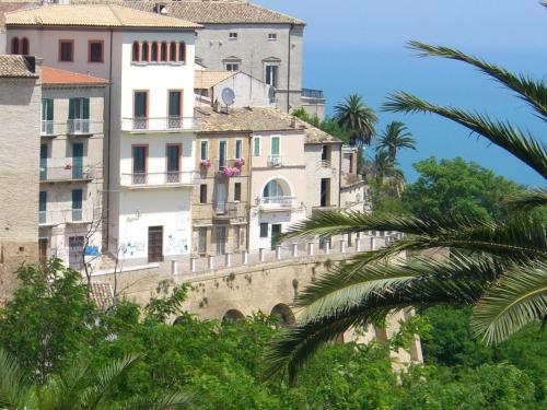 a building on top of a hill with trees at Casa in Piazza in Vasto