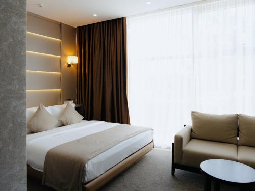 Ένα ή περισσότερα κρεβάτια σε δωμάτιο στο City Stay Bishkek