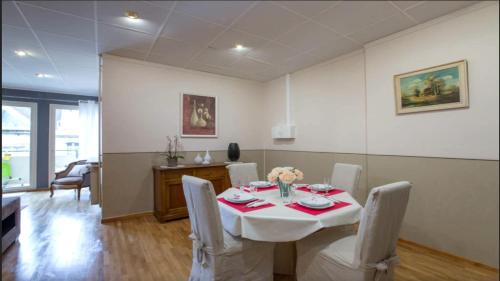 une salle à manger avec une table et des chaises blanches dans l'établissement Le petit Paris-Hyper centre METZ, à Metz