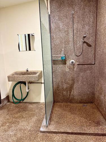 a bathroom with a shower and a sink at Ardour Lodge "B" Wing in George Town