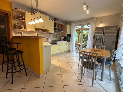 une cuisine avec une table et des chaises dans l'établissement Gîte Des Fruitiers, à Orbey