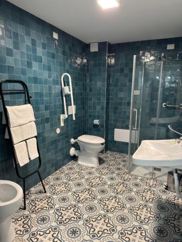 a bathroom with a toilet and a shower and a sink at Di Prima Albergo Diffuso in Catania