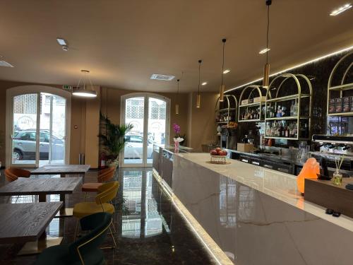 a bar with tables and chairs in a restaurant at 20Miglia Albergo Diffuso - Via Giovanni Di Prima in Catania