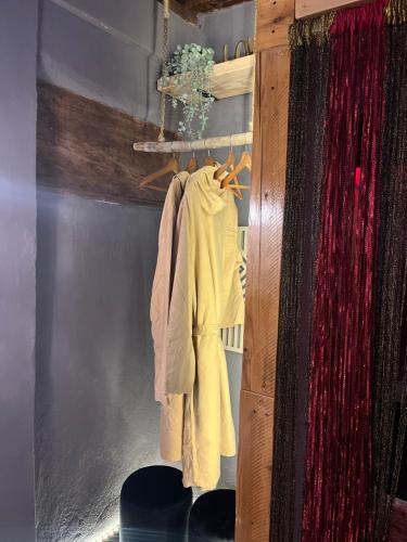 a closet with a rack with a yellow shirt on it at Chalet 44 in Pinerolo