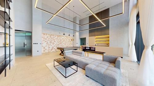 a living room with a couch and a table at The Community Jumeirah Village in Dubai