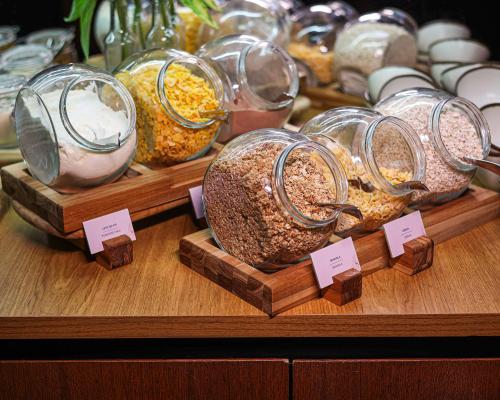 a display of different types of food in glass jars at Radisson RED Campinas in Campinas
