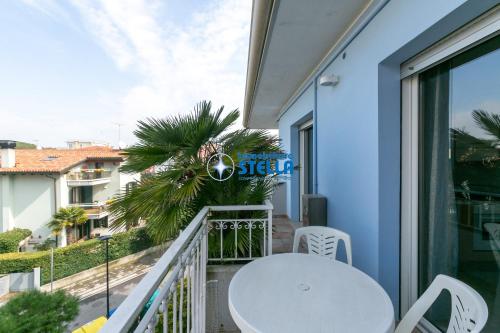 a balcony with a white table and chairs at Residence Adriatica in Lido di Jesolo
