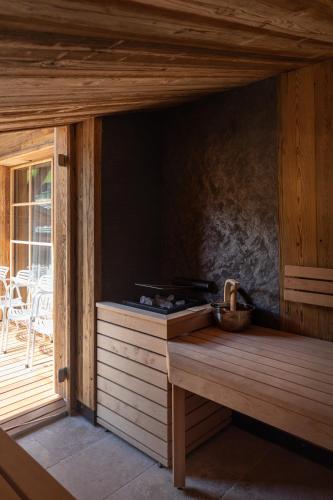 a wooden room with a counter and a table at Raffl's Tyrol Hotel in Sankt Anton am Arlberg