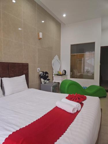a bedroom with a bed with two towels on it at Love Hotel - Khách Sạn Theo Giờ in Da Lat