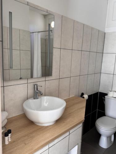 a bathroom with a white sink and a toilet at Hotel Le Golfe Bleu in Cavalaire-sur-Mer