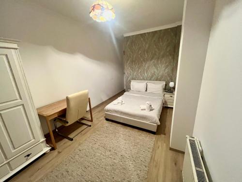 a small room with a bed and a desk at Catedrala Blue in Constanţa