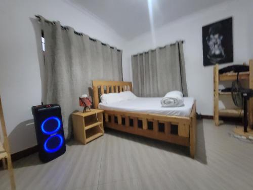 a bedroom with two beds and a suitcase in it at EMMY'S HIDE AWAY in Iringa
