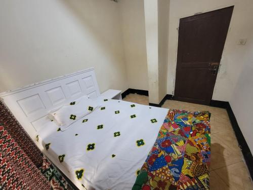 a bedroom with a bed with bugs on it at EMMY'S HIDE AWAY in Iringa