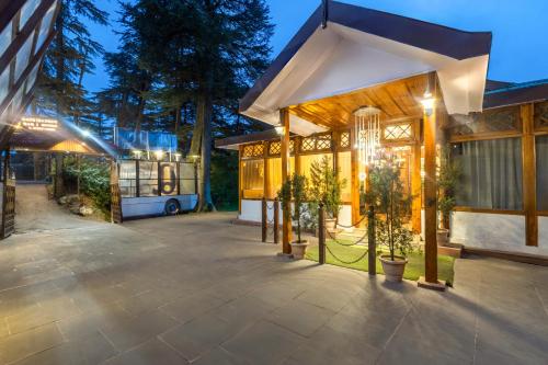 a large building with a bus in the background at Treebo Premium Torrentium - A Heritage Hotel in Shimla