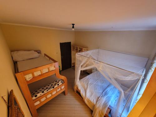a small room with two bunk beds and a small bed at EMMY'S HIDE AWAY in Iringa