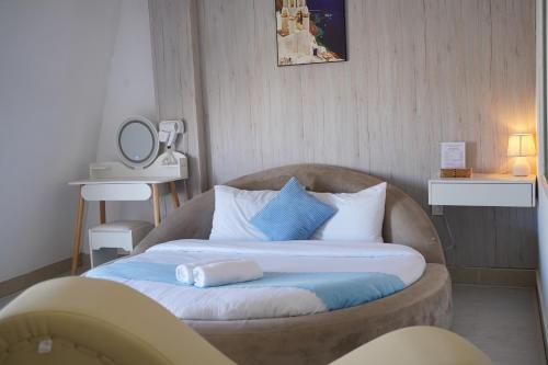 a large bed in a room with a couch at Love Hotel - Khách Sạn Theo Giờ in Da Lat