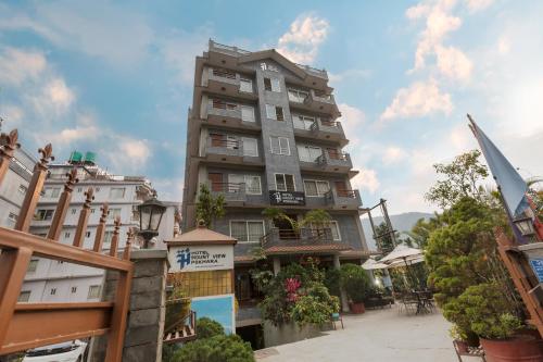a tall apartment building in a city with plants at Mount View Pokhara in Pokhara