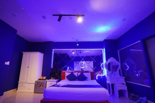 a blue bedroom with a bed and a purple ceiling at Love Hotel - Khách Sạn Theo Giờ in Da Lat