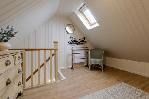 a attic room with a staircase and a chair at 1 bed home in Eckington in Eckington