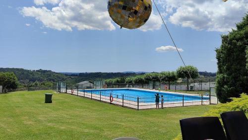 a large pool with a person standing next to it at Casa Grande de Covas-Apartamentos Turísticos in Taboada