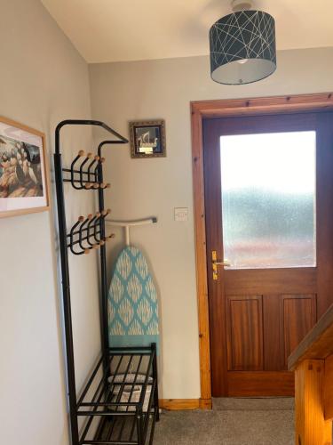 a room with a towel rack next to a door at Apartment 1, Craigmore in Lerwick