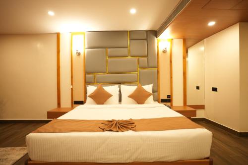 a bedroom with a large bed with a large headboard at Pristine Pavilion Hotel in Shillong