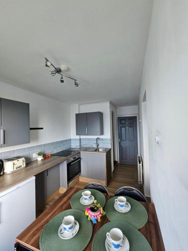 a kitchen with a table with two plates on it at 1 Bedroom Apartment in Poole in Poole