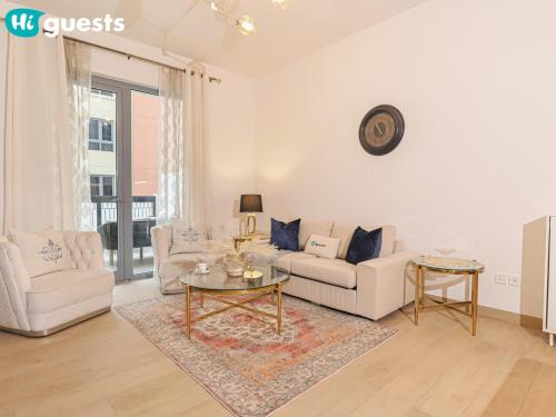 a living room with a couch and a table at HiGuest - Spacious 1BR Apt in La Mer with Gym & Parking in Dubai