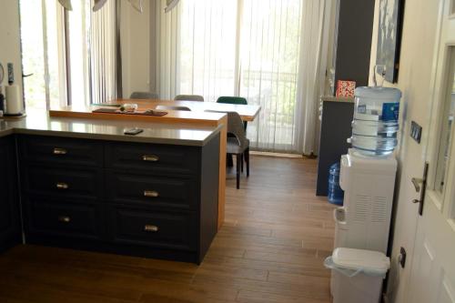 a kitchen with a desk with a large bottle of water at Proto Villa in Sarigerme