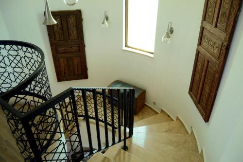 a stairway with a black railing and a window and door at Proto Villa in Sarigerme