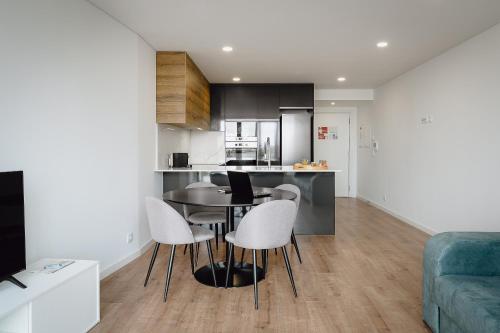 a kitchen and living room with a table and chairs at Feel Porto Lapa Collection Flats in Porto