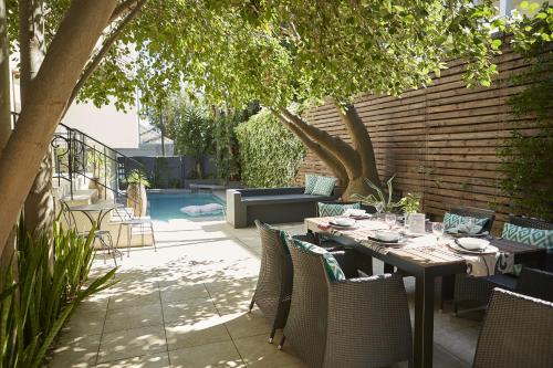a table and chairs sitting on a patio at Bayflowers Guest House in Cape Town