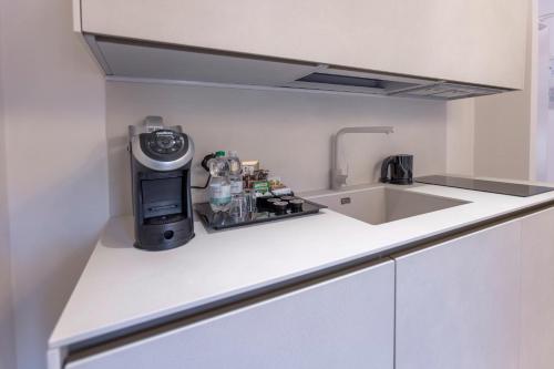 a kitchen with a sink and a counter top at Opera Relais De Charme - Aparthotel in Verona