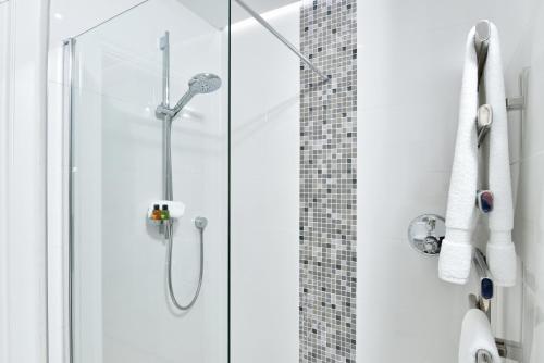 a shower with a glass door in a bathroom at Apartment 1 24 Cathedral Yard Cathedral View in Exeter