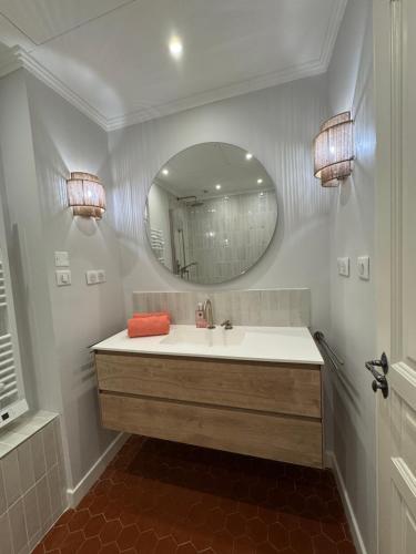 a bathroom with a sink and a mirror at Maison du Lac in Grimaud