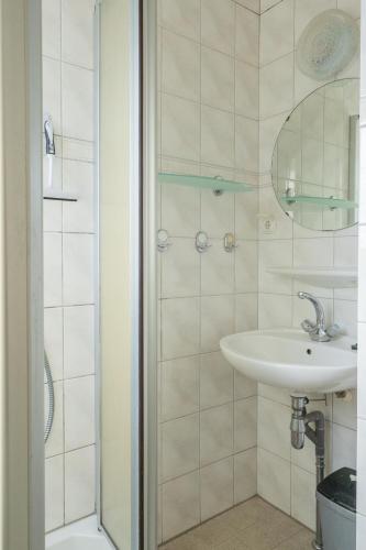 a bathroom with a sink and a shower at Joossesweg 94 in Westkapelle