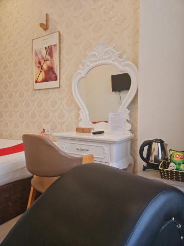 a bedroom with a white dressing table and a mirror at Love Hotel - Khách Sạn Theo Giờ in Da Lat
