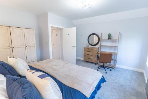 a bedroom with a bed and a mirror and a desk at The Enchanting Silver Birch Retreat, New Forest in Ower